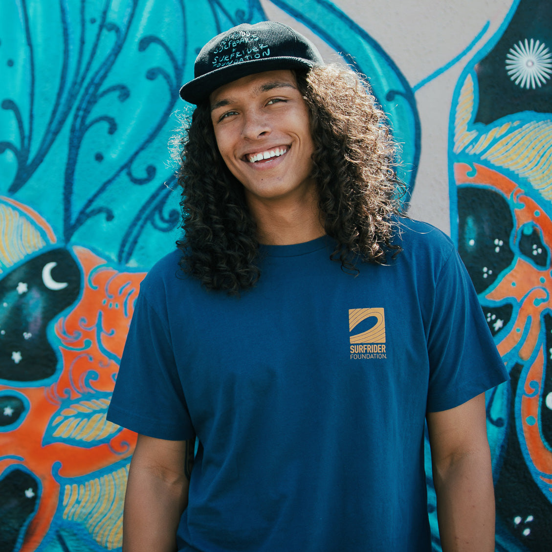 Front view of navy tee with yellow logo. 