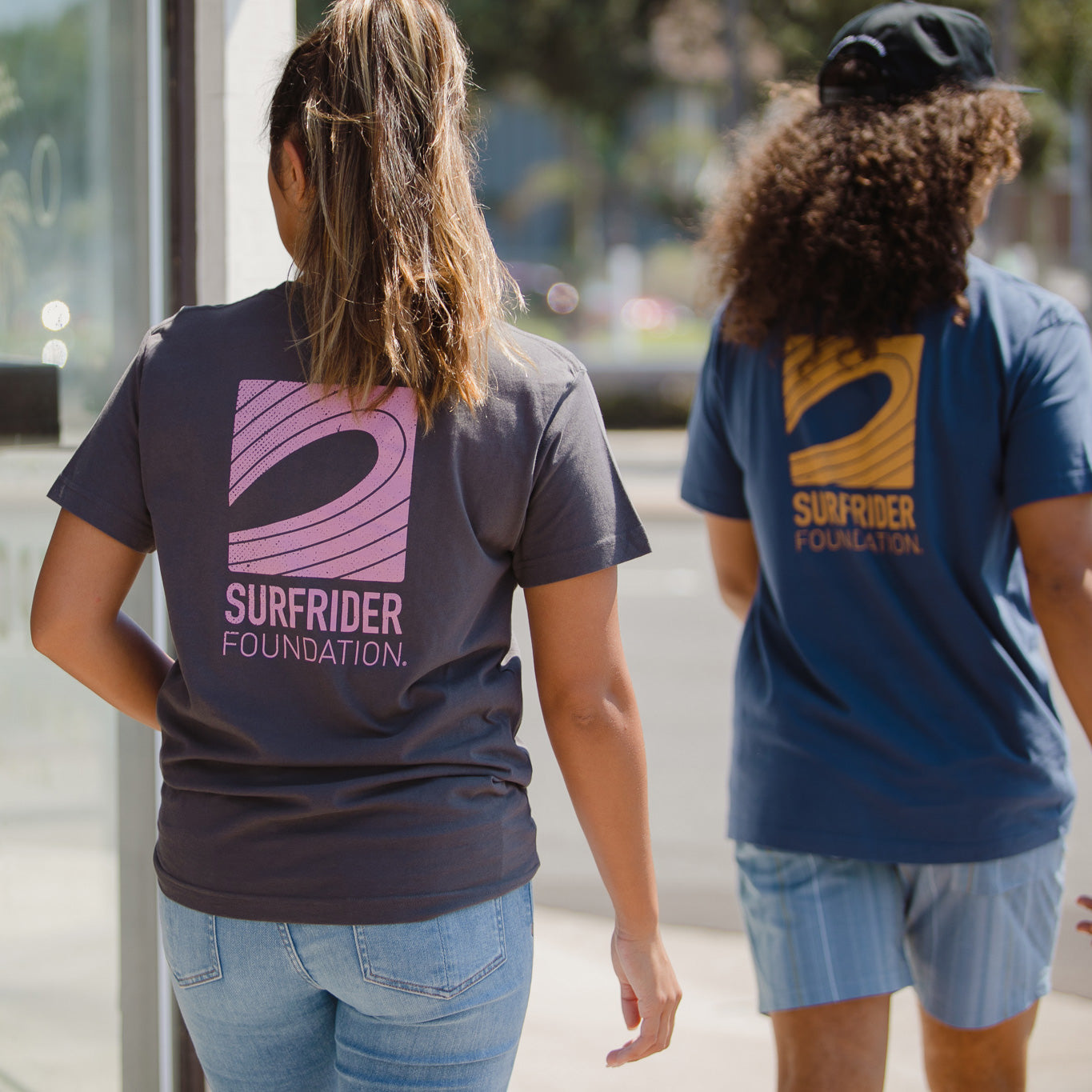 Back detail of pink graphic on shirt on a model. 