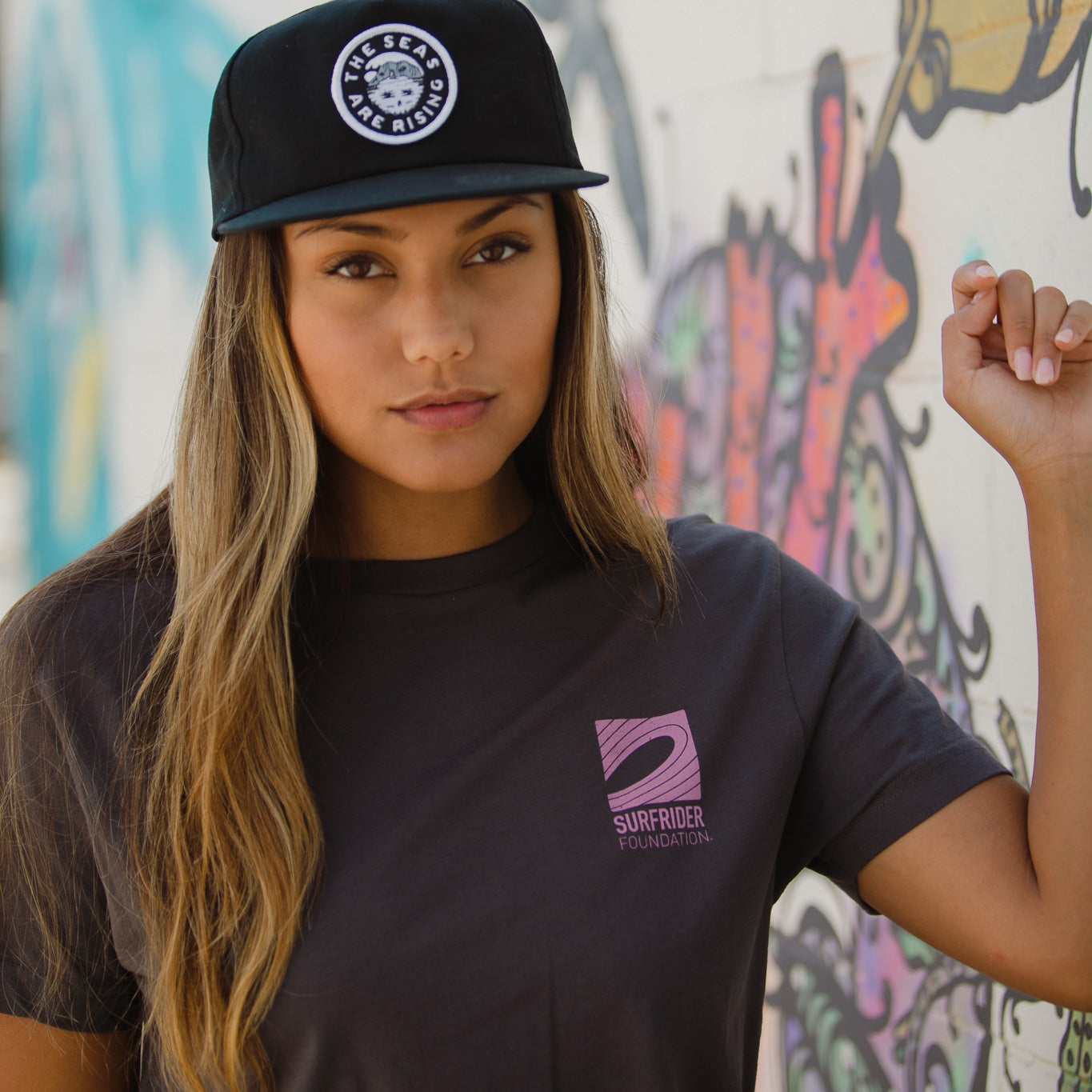 Front detail of graphic on the front corner of the tee on a model. 